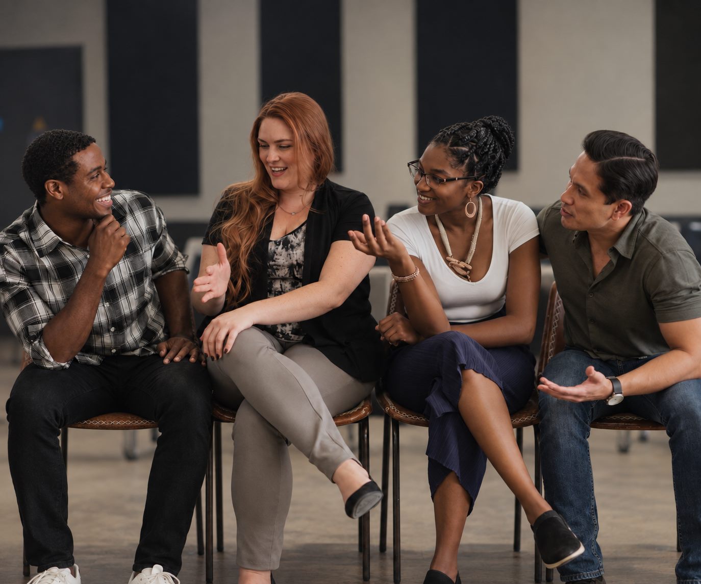 Two couples seated together, talking.