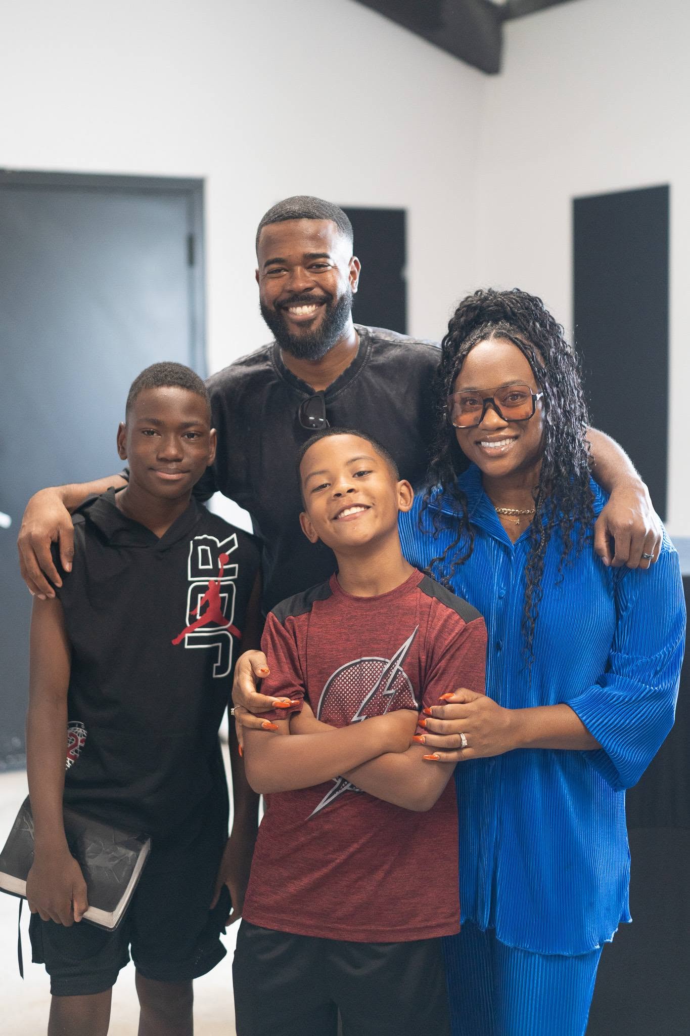 A family of four standing together.