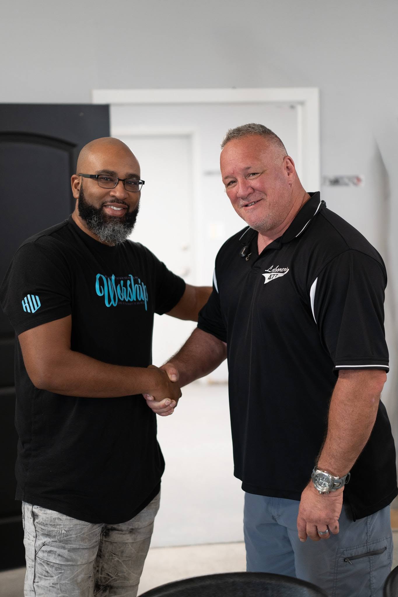 Two men shaking hands at the gathering.